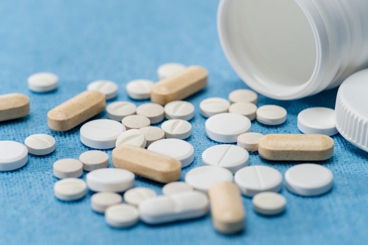 Medication pills on medical blue background